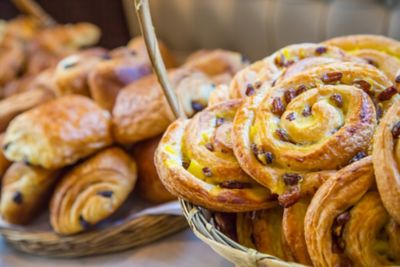 An assortment of pastries piled up high, part of a traditional French breakfast