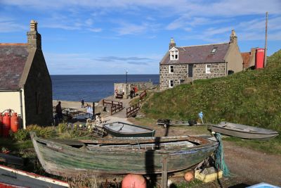 Cottages and a fishing boat in quaint Crovie village on the Aberdeenshire coast