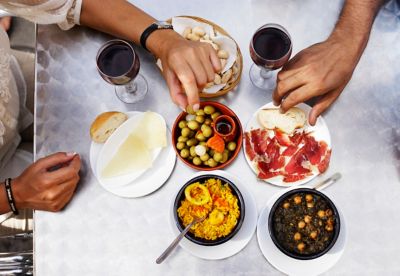 Couple sharing tapas at an outdoor restaurant