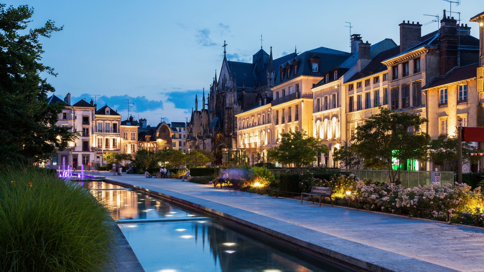 Evening Promenade in Troyes, France: Canal Lit by Illuminated Buildings