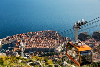 A cable car soaring above Dubrovnik's Old Town and the Adriatic Sea