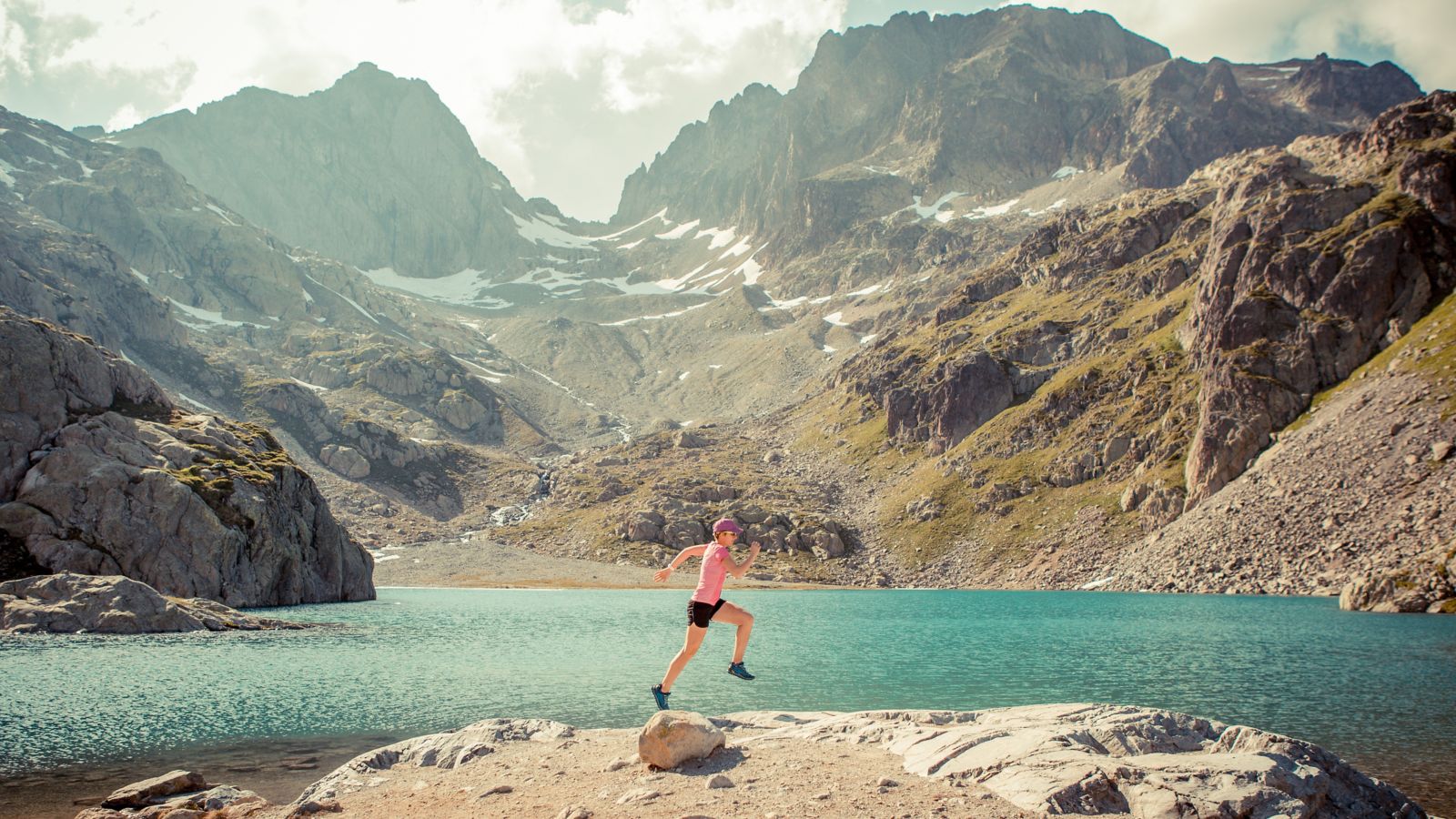 A runner by Lac Blanc against a backdrop of rugged mountains in Chamonix, France