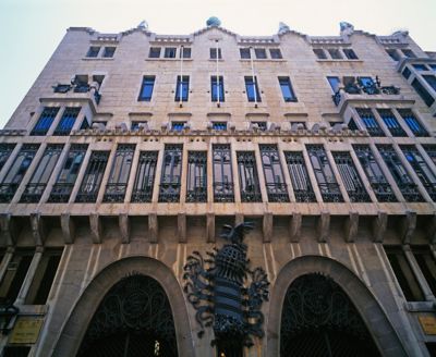 The imposing limestone façade and intricate metalwork of Gaudí's Palau Güell in Barcelona