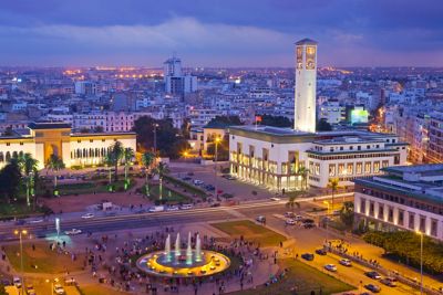 Mohammed V Square in Casablanca in the evening, with fountains and palm trees