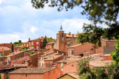 Orange rooftops against a blue sky in Roussillon village, Provence