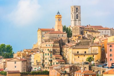 Ochre-coloured buildings and a clock tower in Grasse near Nice, France