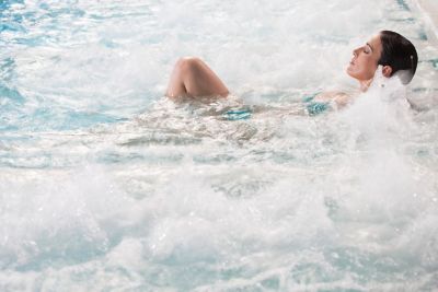 A person enjoying the regenerative power of water in a hydrotherapy pool