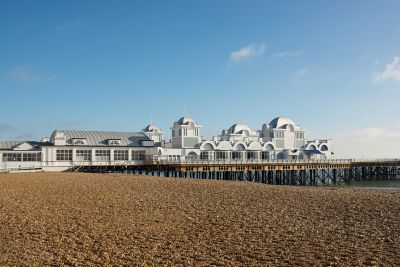 Grey and white buildings overlooking the beach at Southsea Pier in Portsmouth
