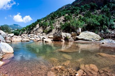 Paradise Valley near the Atlas Mountains in Morocco, with a rocky pool backed by scrub-covered cliffs