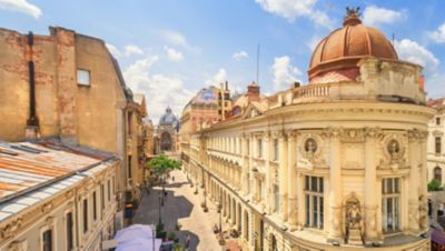 Bucharest Old Town's historic façades and a cobbled street on a sunny day