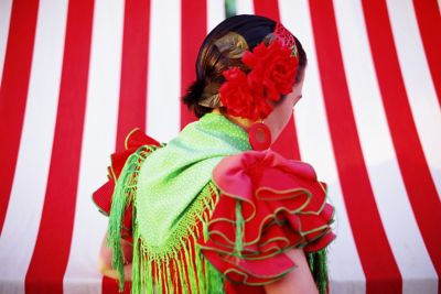 A flamenco dancer in Seville, wearing an elaborate green and red costume