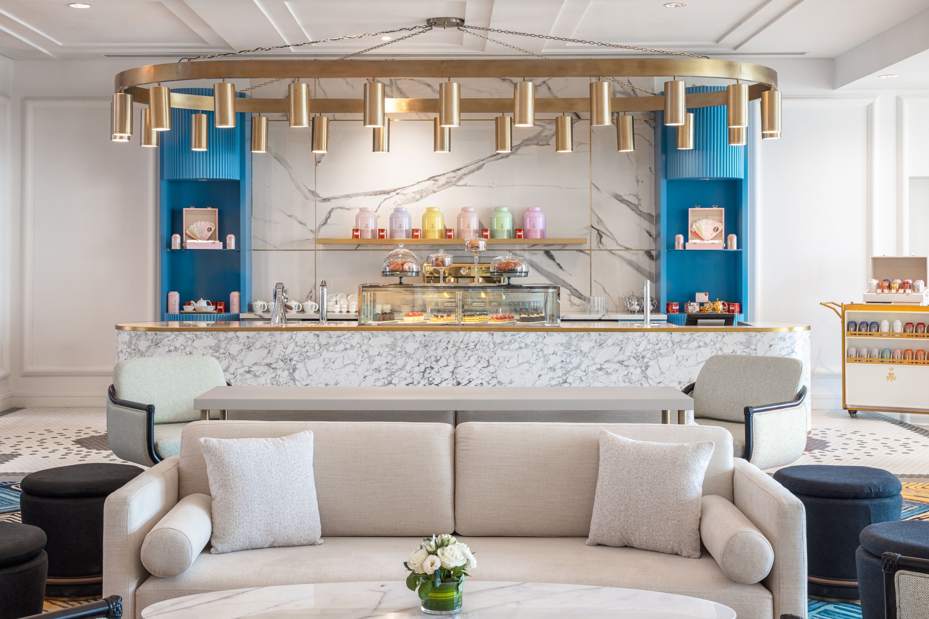 Elegant Hotel Cafe with Pastry Display and Stylish Seating
