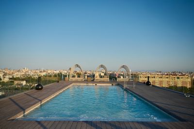 The rooftop swimming pool at Novotel Valencia Lavant, with loungers and skyline views