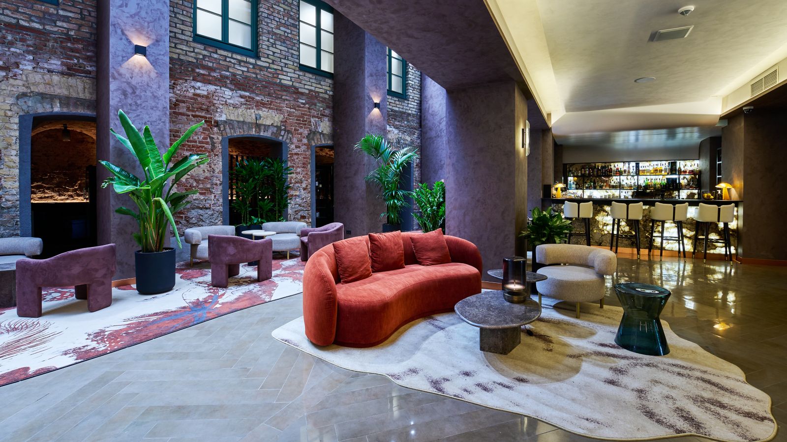 The open-plan lobby at Pullman Riga Old Town, with exposed brick walls and a bar
