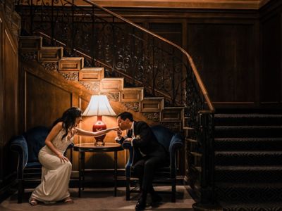 bride and groom share a moment under the staircase