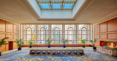 Banquet space with tall windows and lots of sunlight
