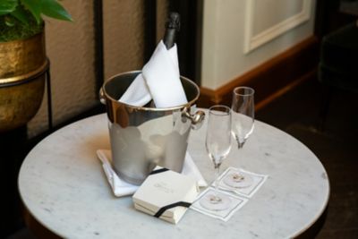 champagne and a treat box on a table