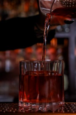 red cocktail being poured