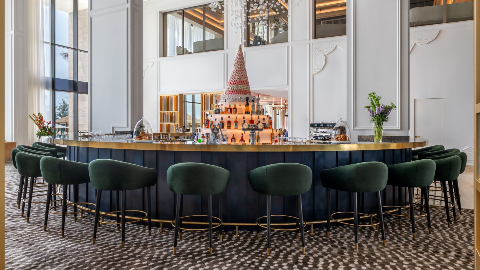 Luxurious Hotel Bar with Gold Accents and Macaron Display