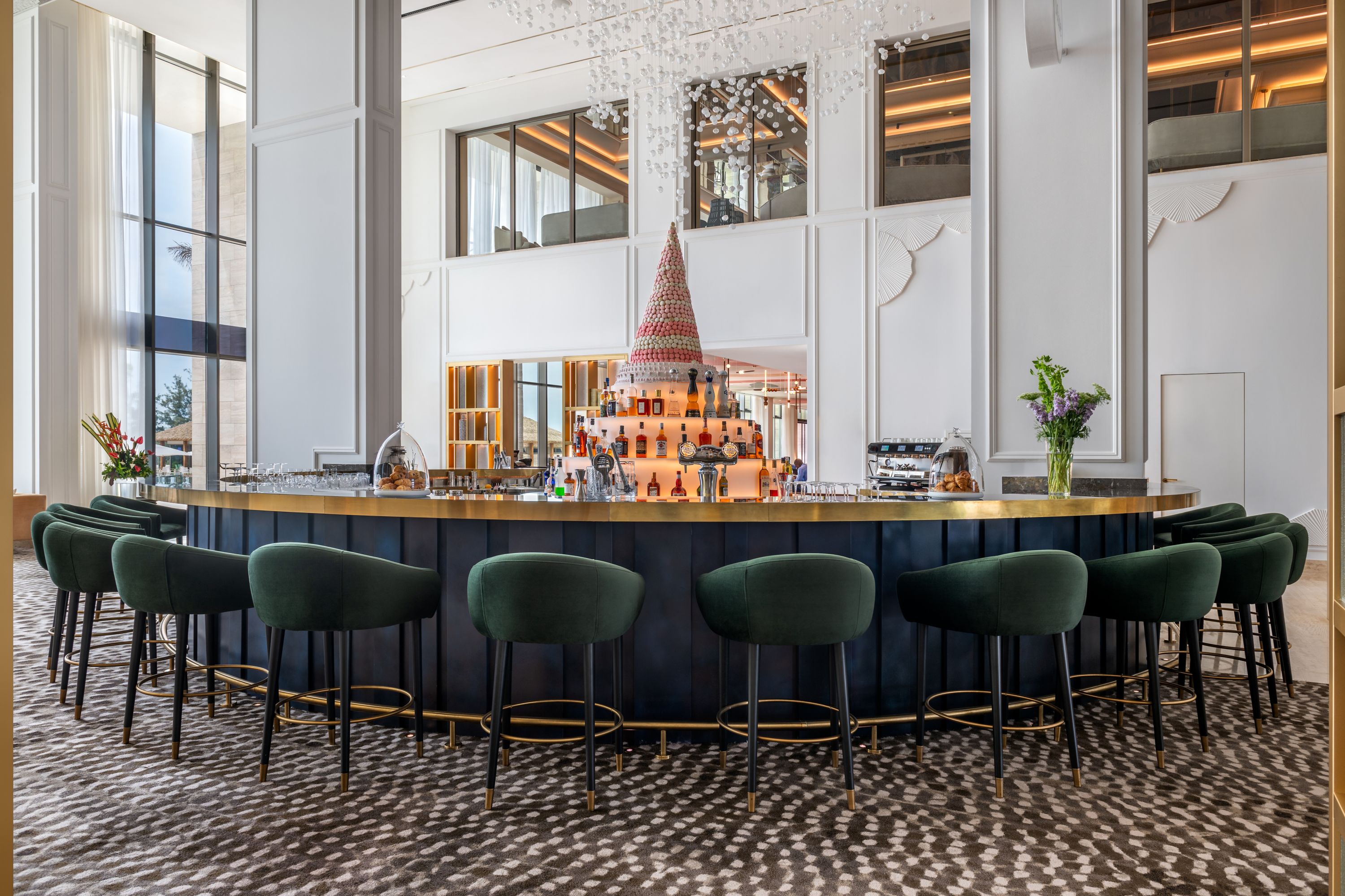 Luxurious Hotel Bar with Gold Accents and Macaron Display