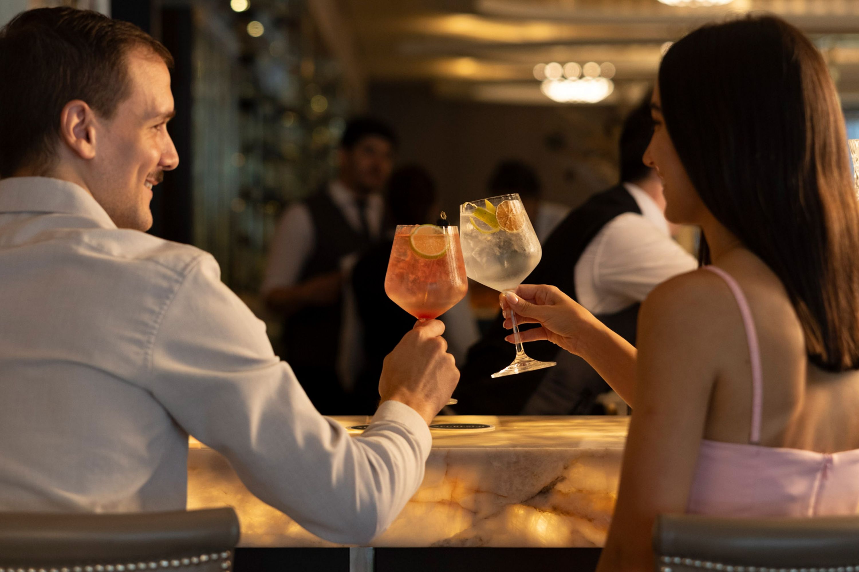 Cheers to a Night Out: Couple Enjoys Drinks at a Hotel Bar