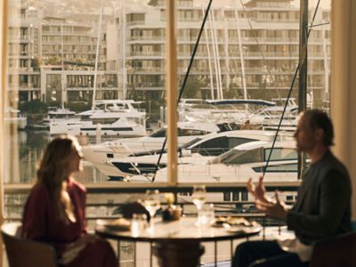Couple enjoying a romantic dinner besides the marina at Cape Grace in Cape Town