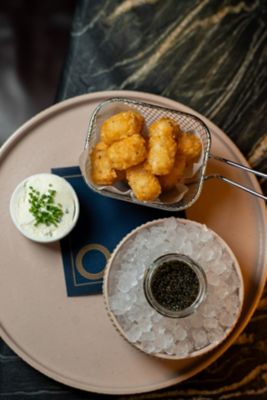 Caviar and tater tots with creme fraiche