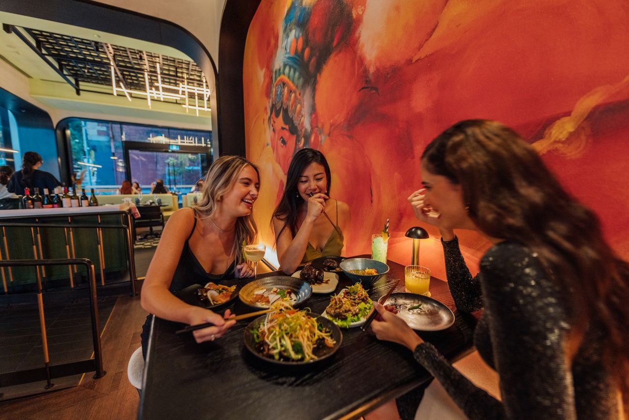 Friends enjoying dinner at the stylish restaurant of Mövenpick Hotel Melbourne on Spencer, Australia