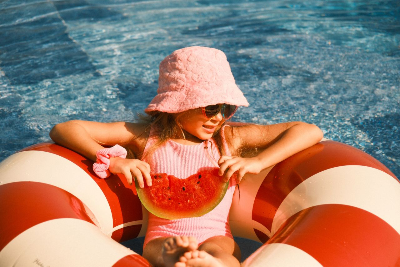 Young girl relaxing in the swimming pool at Mövenpick Ras Al Khaimah during a family holiday