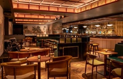 The warmly lit, plush basement restaurant at Oriole cocktail bar in London