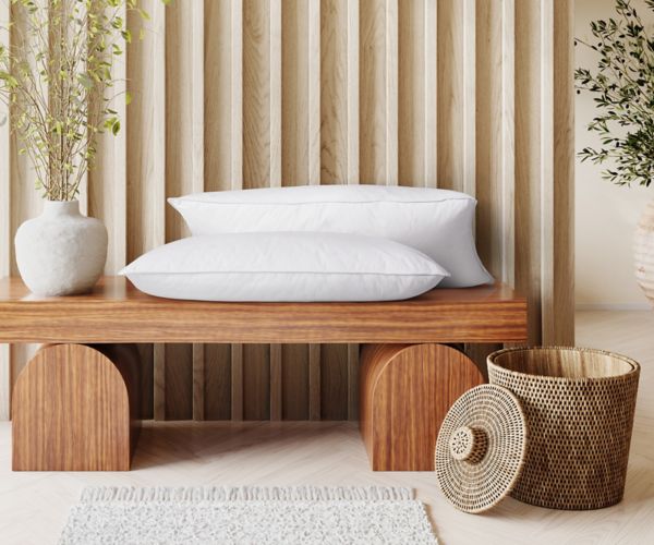 Mövenpick signature hotel pillows displayed in a bright and minimalist bedroom setting