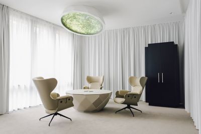 A chic lounge area in Pullman Berlin Schweizerhof, with neutral tones and sunlight