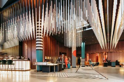 Reception desks under a light sculpture at Pullman Berlin Schweizerhof hotel