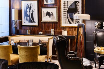 Sofitel Paris Le Faubourg hotel's bar, with velvet chairs and dark wood panelling