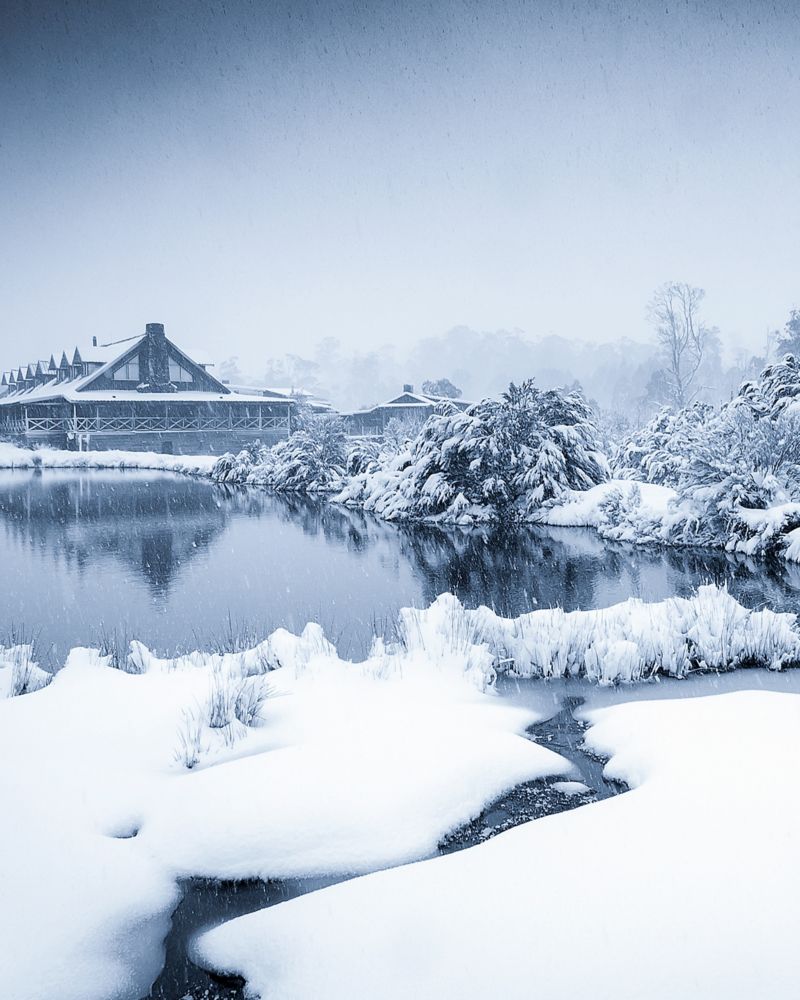 A view of Cradle Mountain blanketed in snow during winter