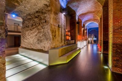 Red-brick walls, exposed stone passageways and vaulted ceilings at Mövenpick Hamburg