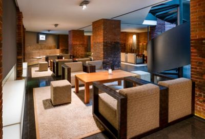 The light-filled underground lobby with exposed brick walls at Mövenpick Hamburg