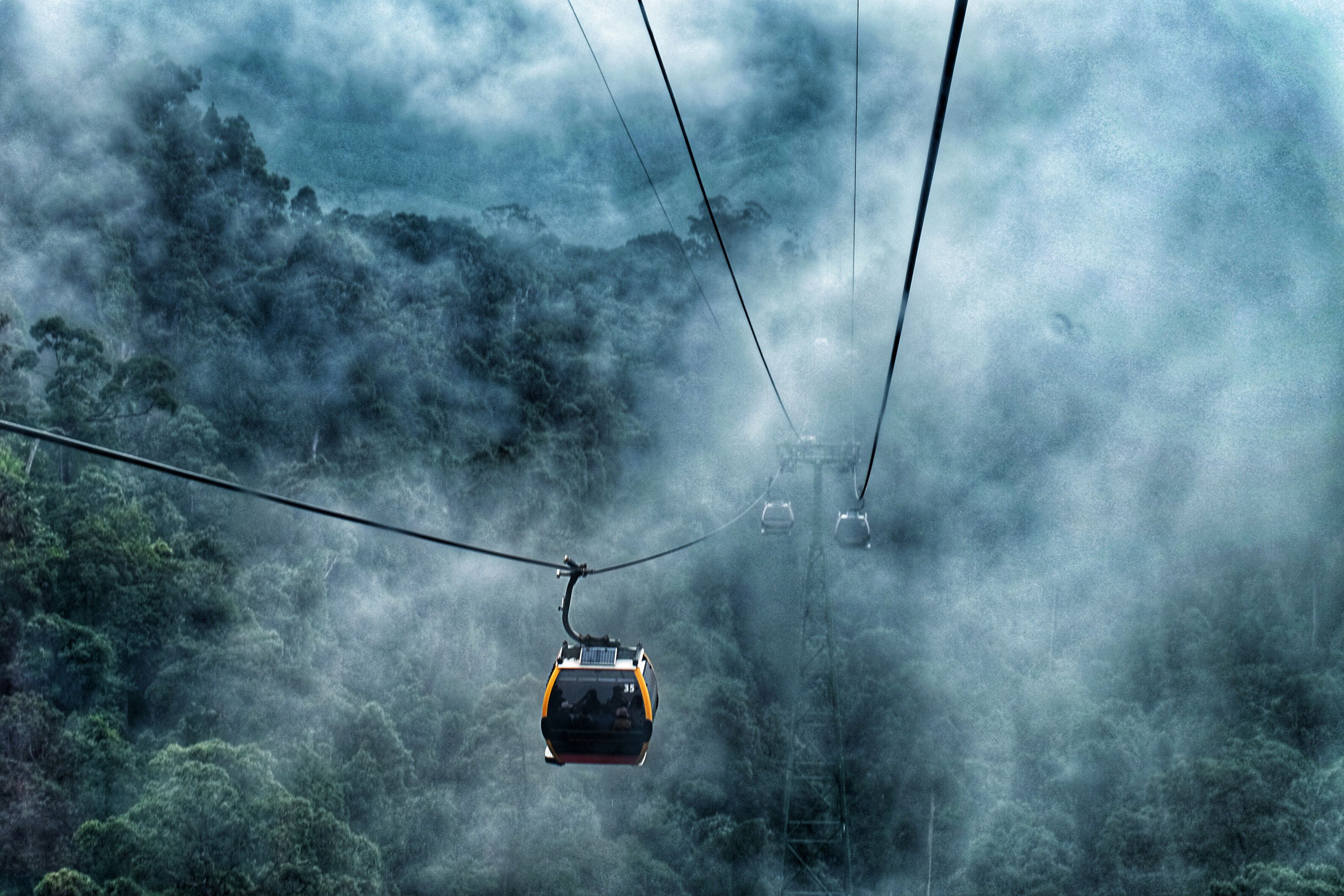 Cable car travelling through misty mountains in Da Nang