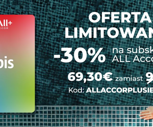A smiling person with a large afro hairstyle, wearing a denim jacket and yellow headphones around their neck, sits on steps. To the left, there is an Ibis logo on a gradient background with red and green hues. Perfect for leisure or business stays, enjoy 15% OFF your next visit!