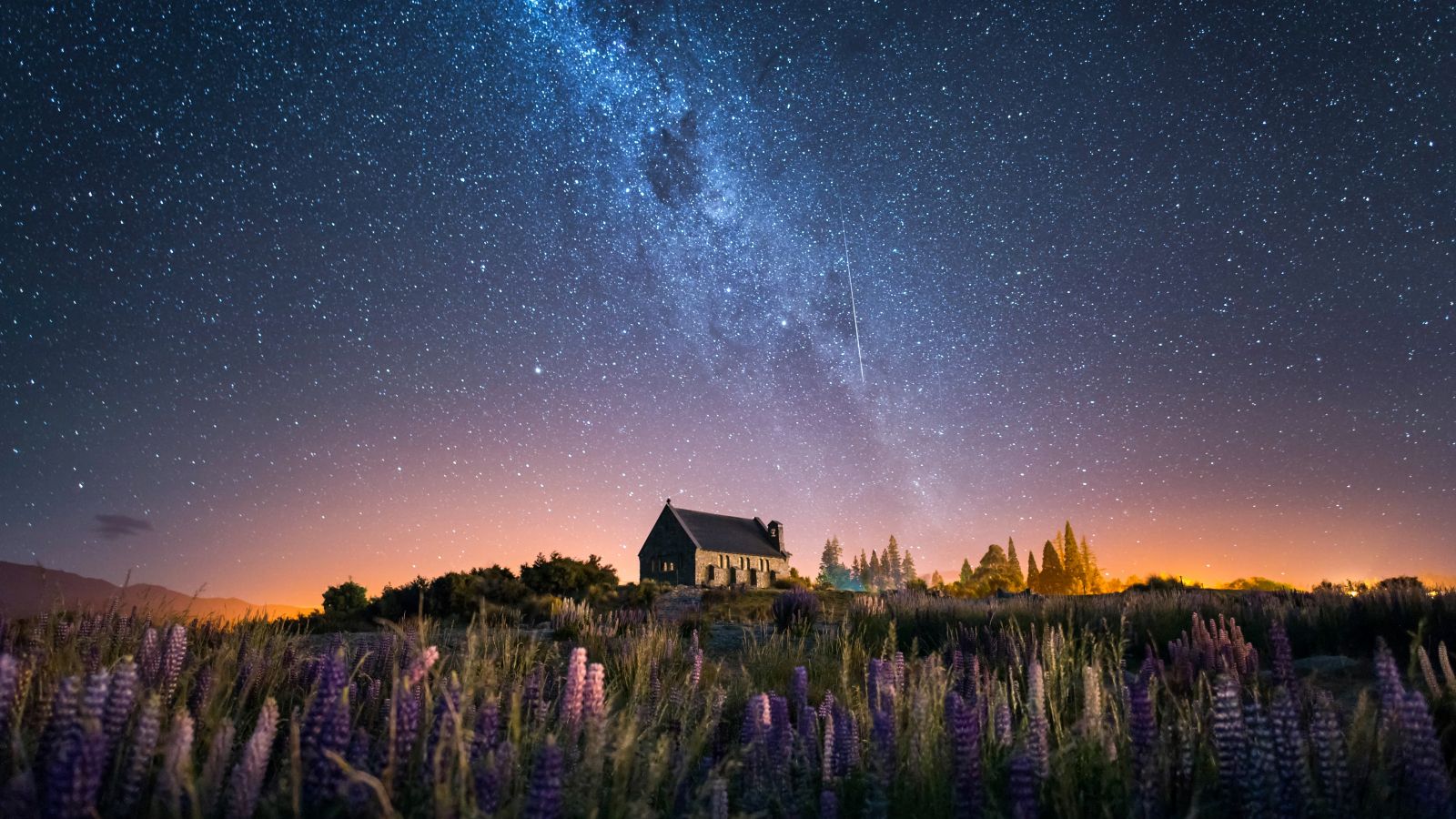 Church of The Good Shepherd and Milky Way with lupins blooming, Lake Tekapo, New Zealand