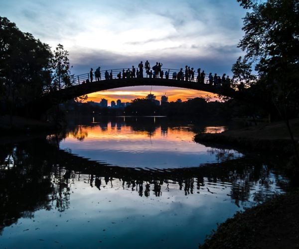 pessoas em uma ponte olhando SP a noite