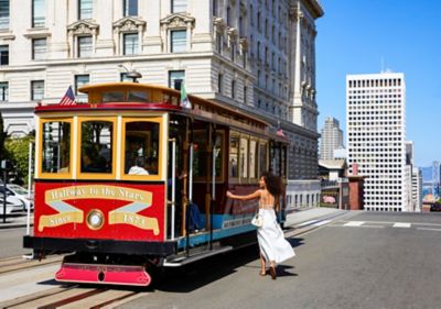Woman Standing Outside Fairmont San Francisco Getting On to a Classic SF Trolley